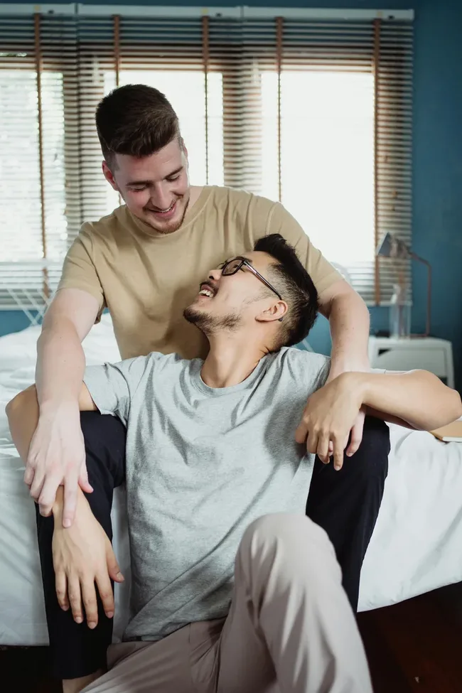Happy gay couple smiling together — same-sex couples therapy at Gay Couples Institute